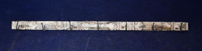 A distressed painted wall mounted coat rack with seven hooks. L.154cm