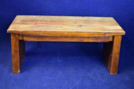 An Eastern teak and studded bench. H.50 W.109 D.45cm