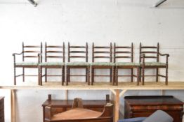 A set of six mid century oak dining chairs to include two carver elbow chairs.