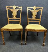 A pair of Edwardian rosewood and satinwood inlaid side chairs.