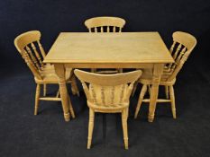 A Victorian style pine dining table and four bar back kitchen dining chairs. Table is H.77 W.108 D.