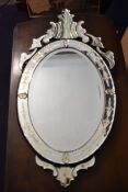 A Venetian style wall mirror with foliate scrolling cresting and etched frame. H.99 W.50.5cm