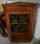 A 19th century mahogany hanging corner cupboard. (Two glass panels missing). H.100