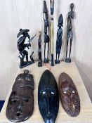 A miscellaneous collection of African tribal carved figures along with three carved masks.
