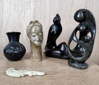 A mixed collection of stone and hardwood Eastern items to include an African pottery vase. H.25cm