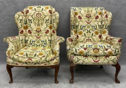 A matched pair of Georgian style wingback armchairs with 17th century style needlework upholstery on