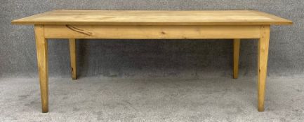 An elm and tulipwood planked top refectory table on square tapering supports. H.76 L.214 D.107cm
