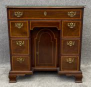 A David Pitt and Sons Georgian style mahogany and satinwood inlaid kneehole desk with brass