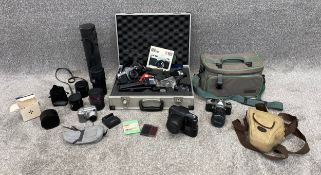 A large collection of photographic equipment to include one Zenith and two Pentax cameras. H.14 W.46