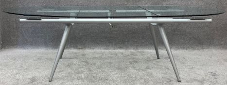 A contemporary Andreas Weber glass and steel DeSalto extending dining table. H.75 W.180 (260
