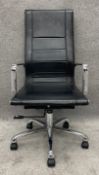 A contemporary black leather and chrome adjustable office chair with tilt and swivel action. H.