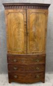 A 19th century mahogany bow fronted linen press fitted with linen slides above three drawers on
