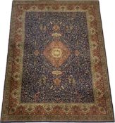 A Persian carpet with a central scrolling foliate medallion on a midnight ground with bird, animal