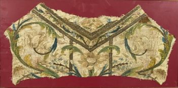 A framed and glazed fragment of a hand stitched crewel work tunic, possibly 17th century. H.48 W.