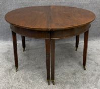 A Georgian mahogany D-end dining table with gateleg action and two extra leaves. H.71 W.120 (236cm