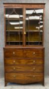 A Georgian mahogany and ebony strung library bookcase, the glazed upper section above fitted