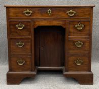A Georgian mahogany kneehole desk with an arrangement of seven drawers on bracket feet. H.78 W.84