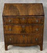 A 19th century flame mahogany and crossbanded bureau. H.107 W.87 D.48cm