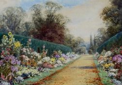 Lilian Stannard (1877-1944), a signed original watercolour. An English garden. Framed and glazed.