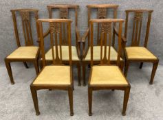 A set of six C.1900 Art Nouveau style carved oak dining chairs to include two carvers. H.110cm (