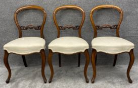 Three Victorian walnut dining chairs reupholstered in piped calico. H.85cm (each)
