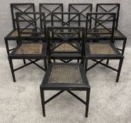 A set of eight contemporary distressed, ebonised, oak and rattan dining chairs by Lombok with