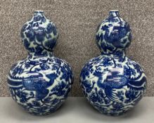 A pair of Chinese blue and white double gourd vases with six character Kangxi marks to the base. H.
