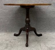 A Georgian mahogany occasional table with tilt top action. H.72 Dia.87cm