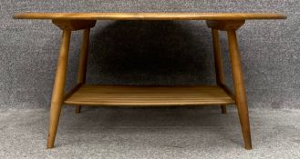 A mid-century Ercol beech and elm oval coffee table, model 454. H.45 W.100 D.83cm