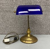 A brass and blue glass banker's desk lamp with adjustable action. H.37 W.28cm