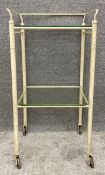 A painted steel early/mid 20th century hospital trolley with glass shelves and an indistinct maker's