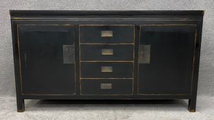 A contemporary Chinese lacquered and ebonised sideboard. H.85 W.154 D.46cm