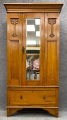 A C.1900 Art Nouveau carved satin walnut wardrobe with a bevel plate mirror. H.193 W.101 D.48cm