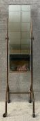 A mid century industrial style cheval mirror with a bevel plate in an adjustable metal frame on