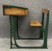 An early to mid 20th century oak and cast iron school desk with it's original ceramic ink well. H.81