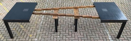 A large contemporary Chinese lacquered and ebonised extending dining table with inset copper