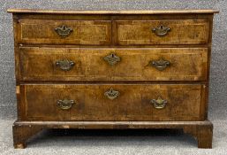 A mid Georgian walnut and featherbanded chest of three long drawers on bracket feet. Possibly with