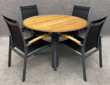 A contemporary Gloster teak and aluminium garden table and chairs with maker's labels. H.74 Dia.