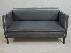 A contemporary Caravane Poppi sofa with matching throw cover. H.65 W.128 D.81cm.