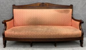 An early 19th century Charles X mahogany framed sofa raised on acanthus carved squat cabriole