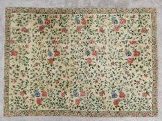 A Kirman hand woven woollen rug, mid 20th century with flowerhead design across a biscuit field