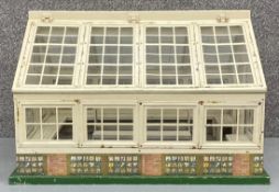A vintage hand built doll's greenhouse by Tri-ang with maker's label. H.38 W.58 D.51cm