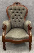 A 19th century carved frame armchair in deep buttoned upholstery. H.110 W.72 D.85cm