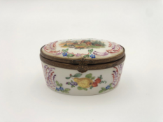 A late 18th or early 19th century German porcelain pill box hand painted to depict hunting scenes.