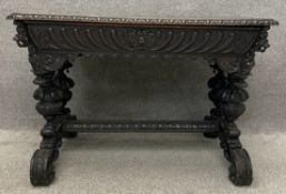 A profusely carved oak 19th century Carolean style side or centre table fitted with frieze drawer on
