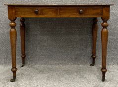 A 19th century mahogany side or writing table fitted with frieze drawers on turned tapering