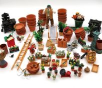 A figure and other effects for a doll's house greenhouse.
