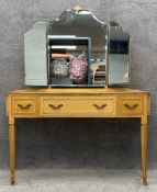 A mid century satinwood French style dressing table with a gilt trim, tapering fluted legs, and gilt