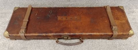 A vintage leather fitted fishing gun and rod case with brass brass fixings, by Monk gun makers, with