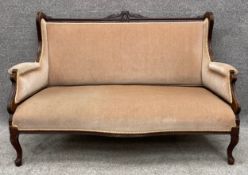 An Edwardian carved mahogany frame two seater canape or sofa. H.88 W.135 D.63cm